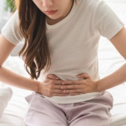 Person touching stomach because of pain and discomfort
