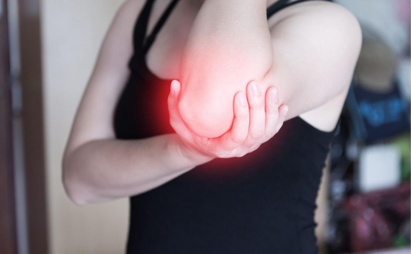 Person holding elbow because of pain and discomfort