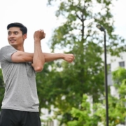 A person stretches his arm upward, showcasing a gesture of enthusiasm or celebration.