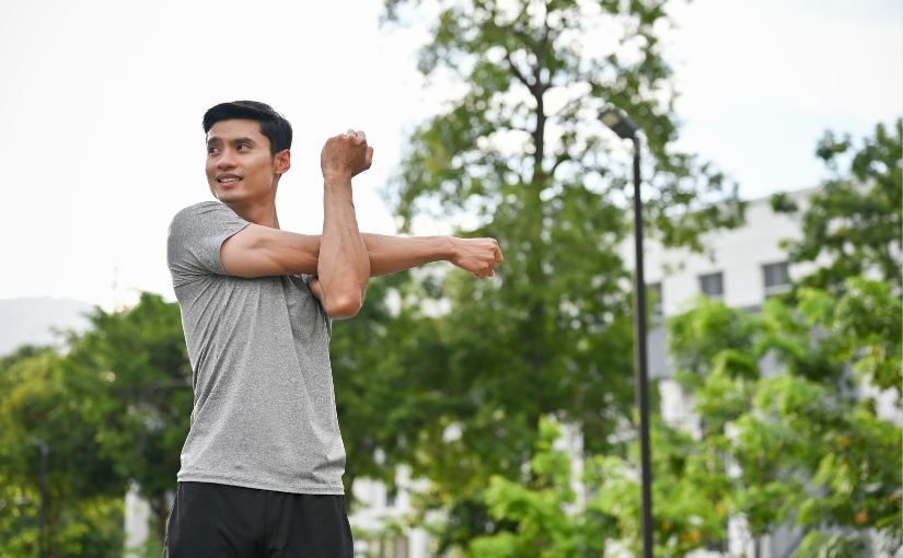 A person stretches his arm upward, showcasing a gesture of enthusiasm or celebration.