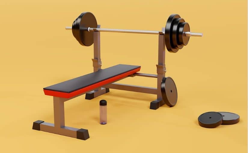 A weight bench with a barbell and weights positioned on either side, ready for strength training exercises.