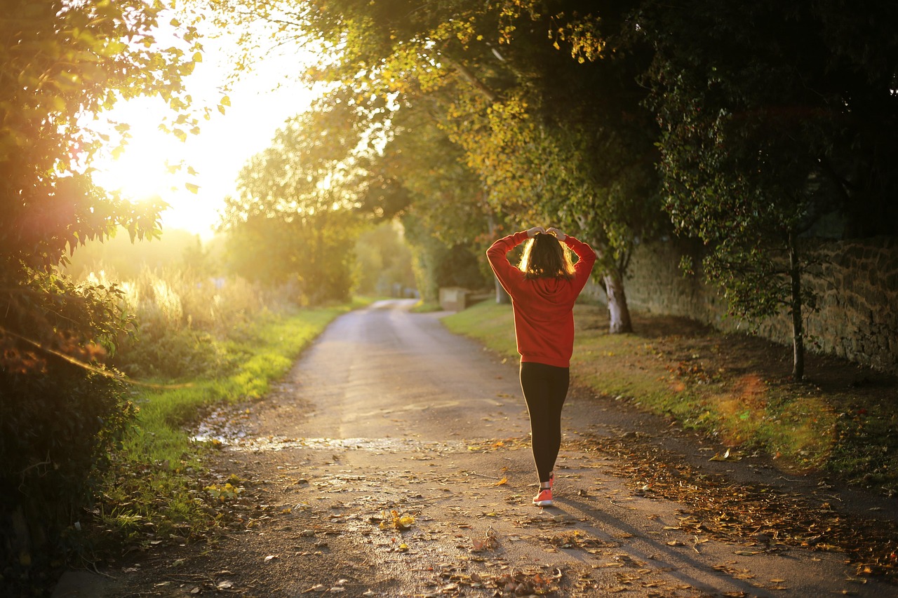 A woman strolls along a road