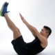 A person performing a side plank exercise, balancing on one arm with his body in a straight line.