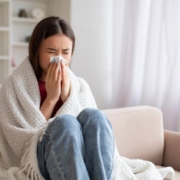 Person sneezing because of flu