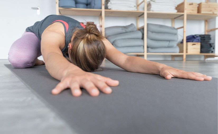 person doing static stretch on the floor 