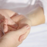 Hands being massaged due to tingling pain
