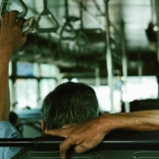 Commuter holding handle on bus