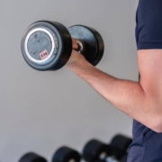 Arms of a person lifting a dumbbell