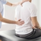 chiro doctor assessing back of patient for pain