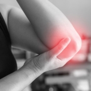 person holding to pain elbow
