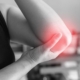 person holding to pain elbow