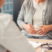 person talking to a doctor with medication on table