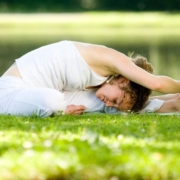 person performing stretching exercises on grass