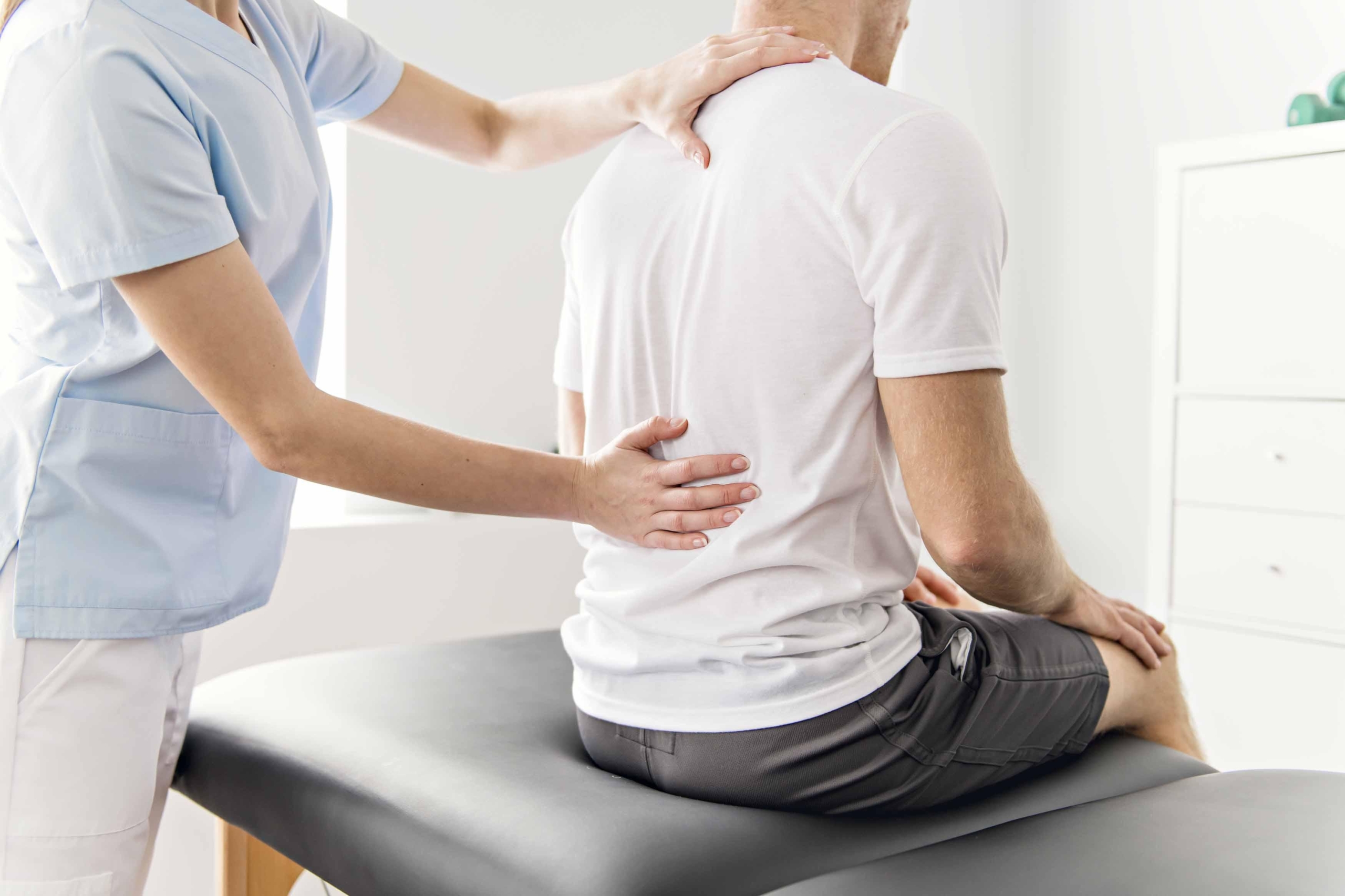 person getting spinal adjustment because of body pain and fever
