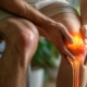 Person holding on to knee because of pain and discomfort
