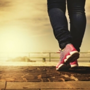close-up shot of a person walking on a stone paved path outdoors