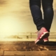 close-up shot of a person walking on a stone paved path outdoors